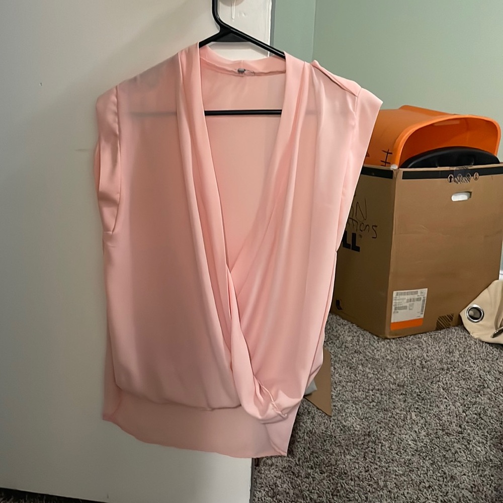 Sheer pink tank top. Mostly open front so need shirt  under